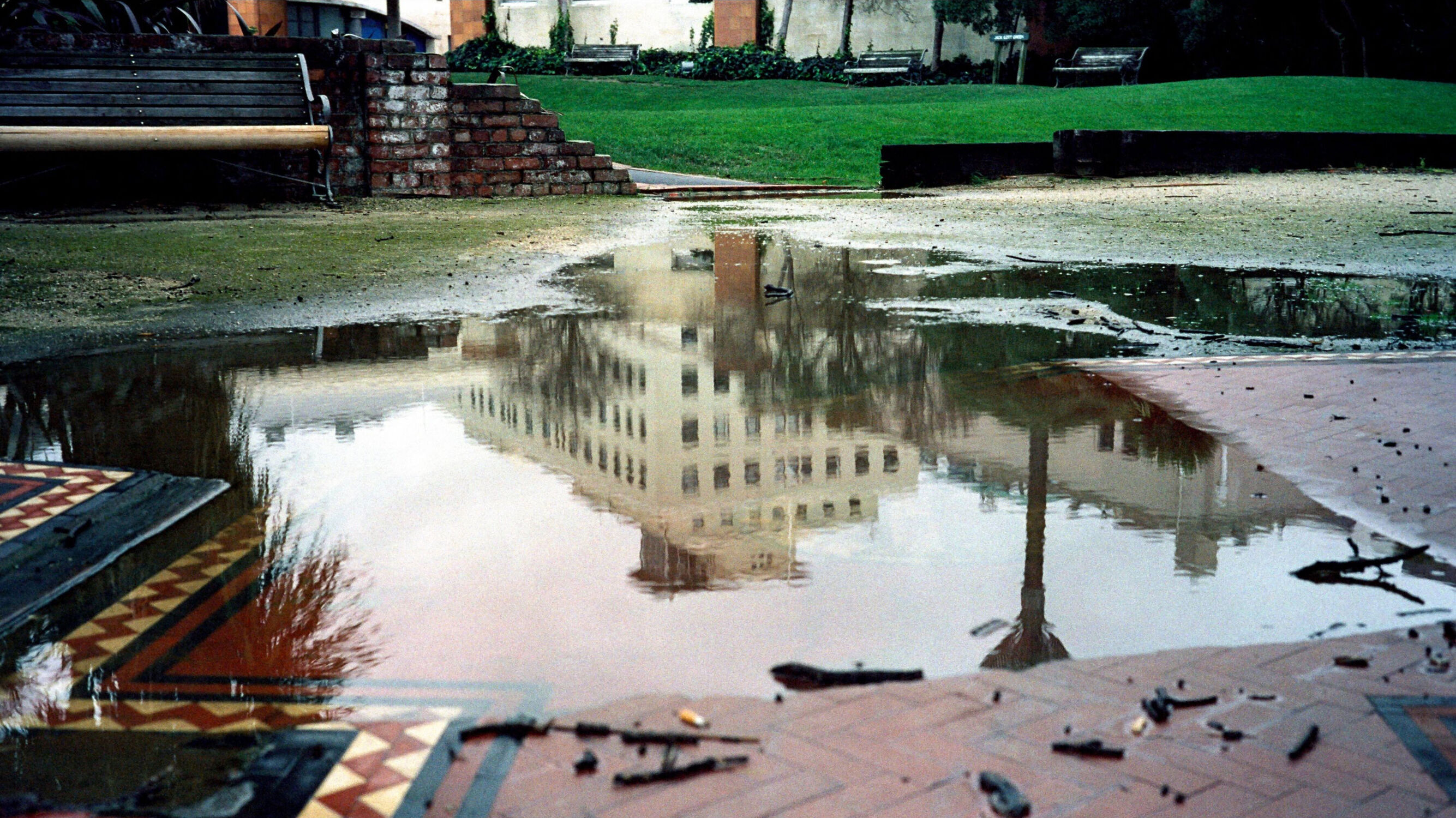The reflection of an old building in a puddle