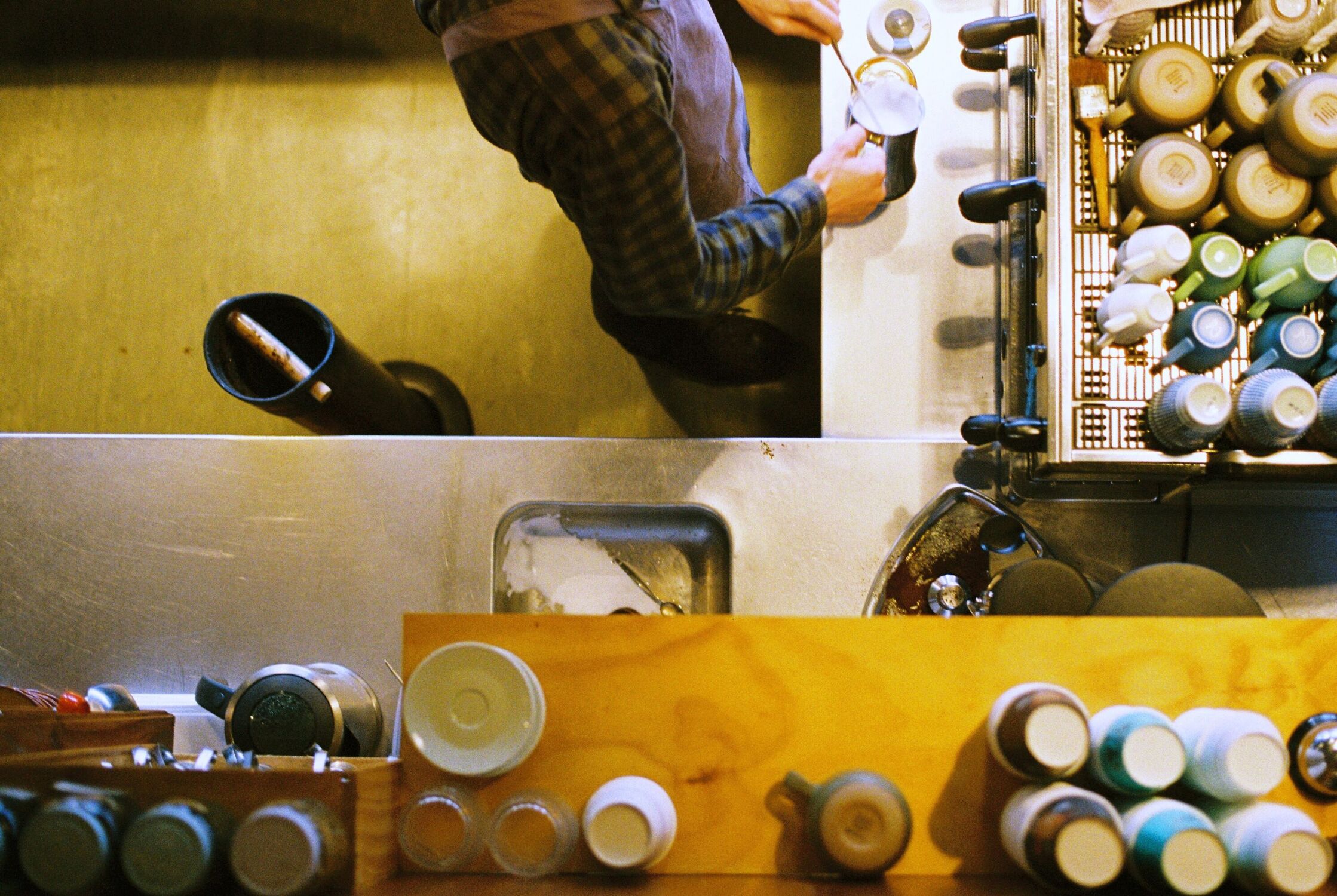 A barista makes espresso shot from directly above