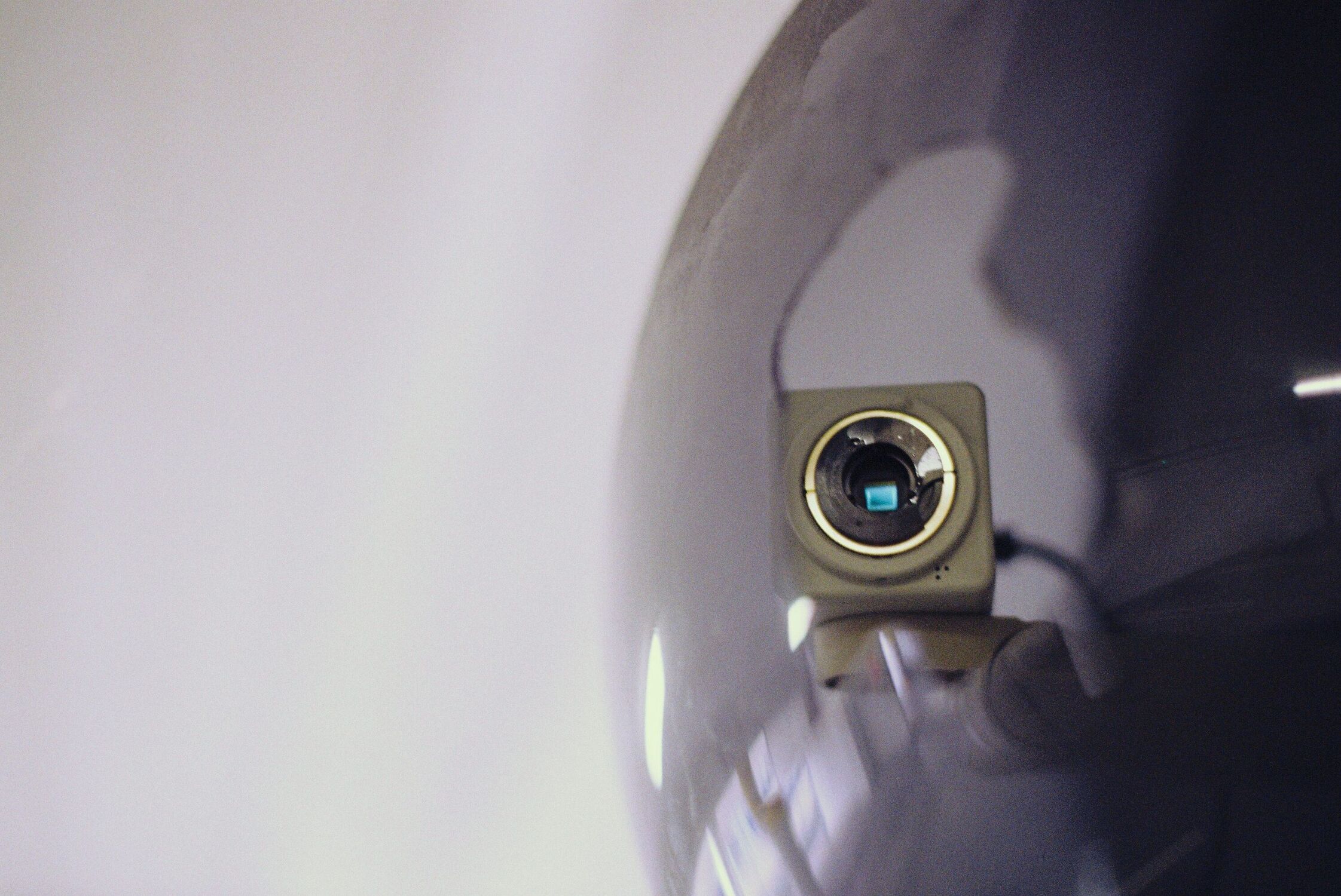 Close up of a security camera that looks directly at you