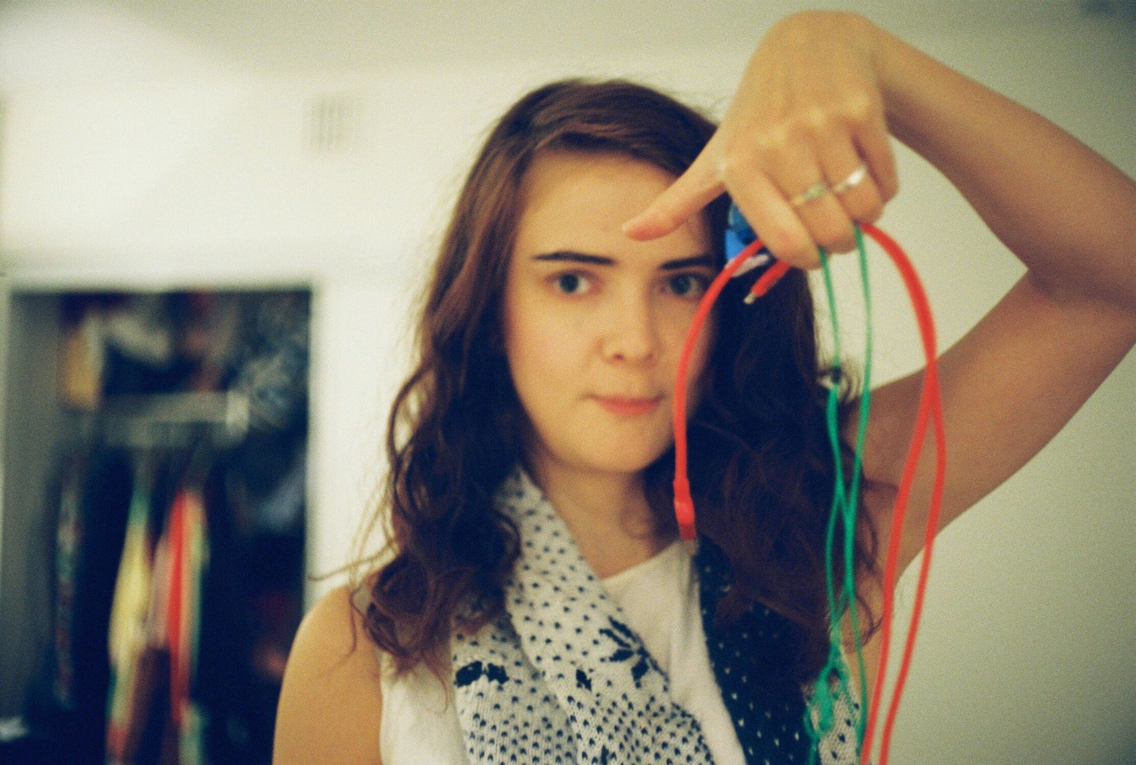 Woman holding up electrical cables (out of focus)