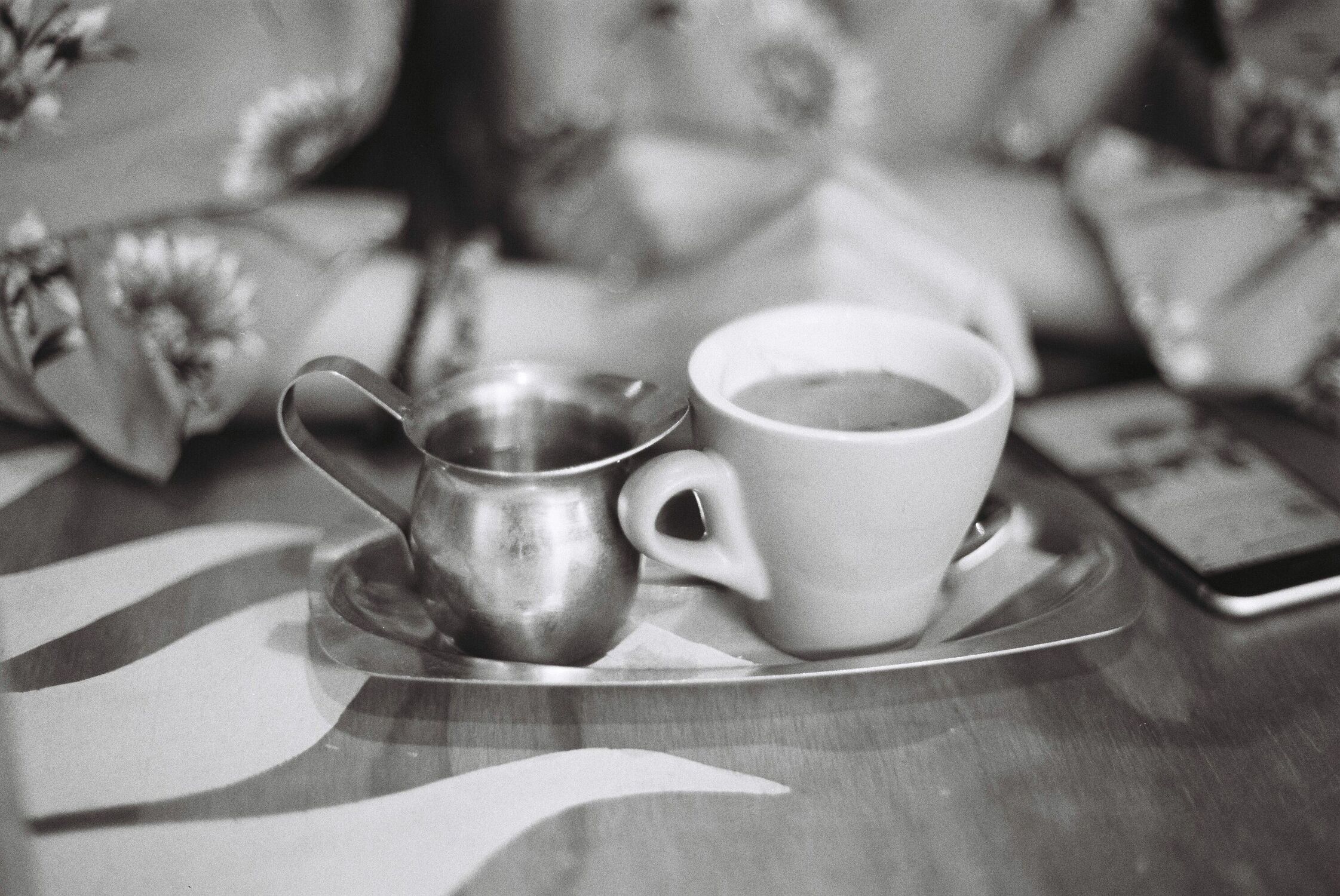 A long black with water on the side(black and white)